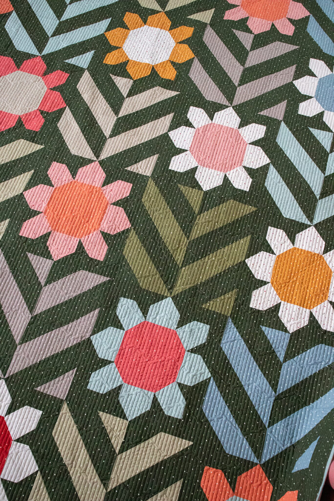 Spring Fling flower quilt in Magic Dot fabric by Lella Boutique for Moda Fabrics. Download the PDF here!