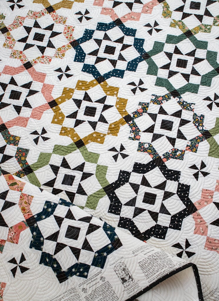 "Glam Squad" tile quilt by Vanessa Goertzen of Lella Boutique. Make it with fat quarters or a dessert roll! Fabric is Imaginary Flowers fabric by Gingiber for Moda Fabrics. Such a beautiful geometric quilt design. Download the PDF here.