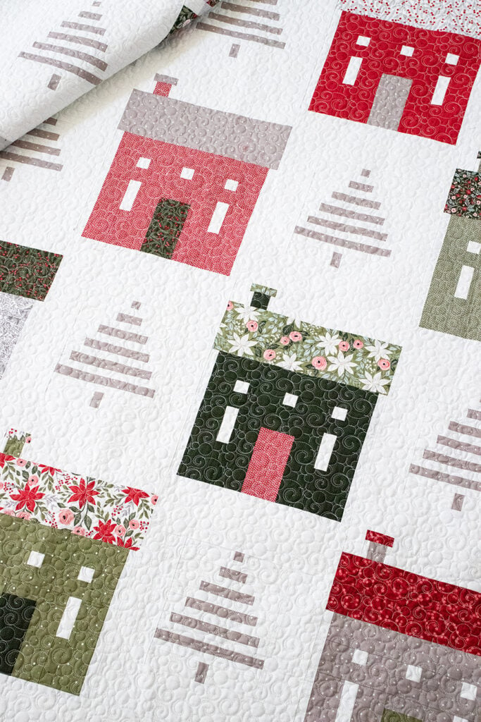 "Holiday House" Christmas neighborhood quilt with simple tree blocks. Fabric is Berry & Pine by Lella Boutique for Moda Fabrics. Download the PDF here!