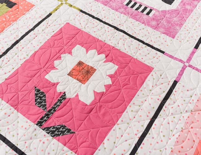 "Haunted Daisy" quilt block by Lella Boutique in Hey Boo fabric. Part of the "Monster Mash" Halloween sampler quilt. Download the PDF here!