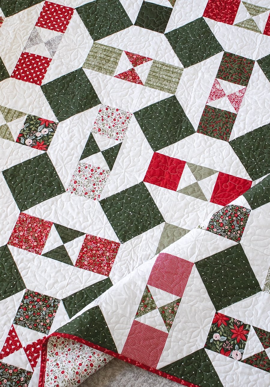 The "Somersault" charm pack quilt from the Charm School book by Vanessa Goertzen of Lella Boutique. Looks like a Christmas ornament quilt In Berry & Pine fabric.