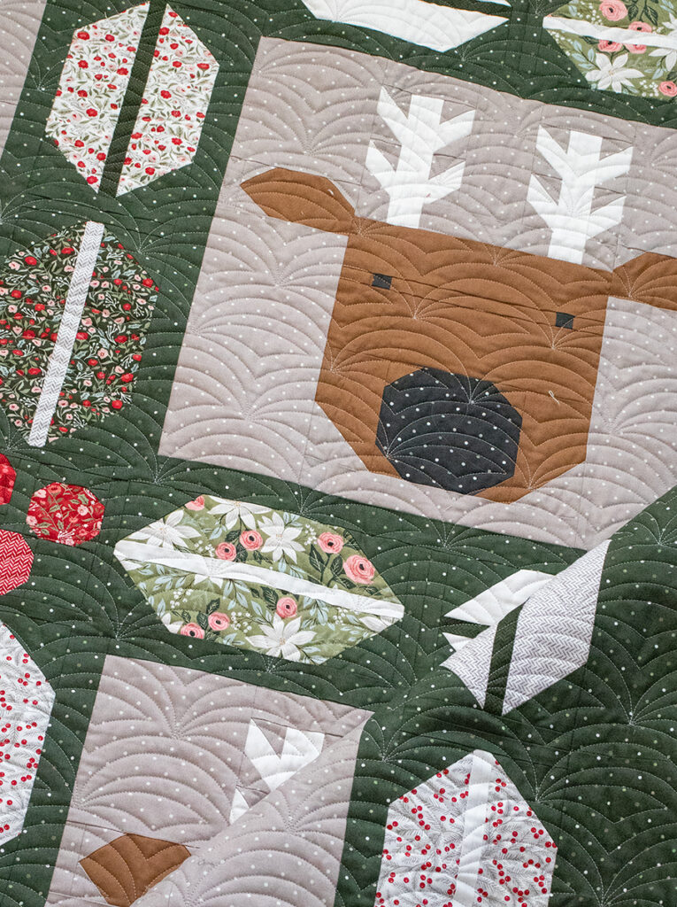 "Christmas Crew" Santa and reindeer quilt with cute holly and berry sashing by Lella Boutique. Jelly Roll friendly, fabric is Berry & Pine by Lella Boutique for Moda Fabrics (May 2025). Download the PDF here!