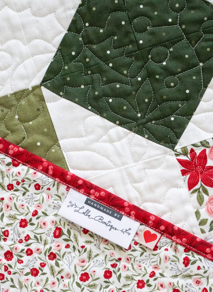 The "Somersault" charm pack quilt from the Charm School book by Vanessa Goertzen of Lella Boutique. Looks like a Christmas ornament quilt In Berry & Pine fabric.