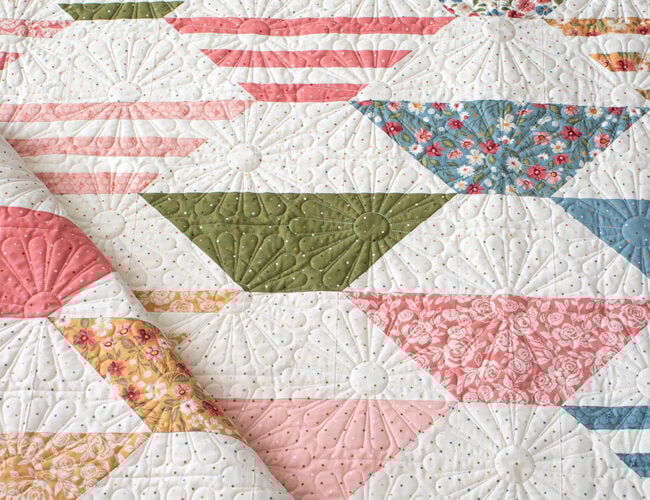 "Honey Glow" honeycomb hexagon quilt by Lella Boutique. Make it with a honeybun + fat quarters. Fabric is Wild Honey (Nov 2025). Download the PDF here.
