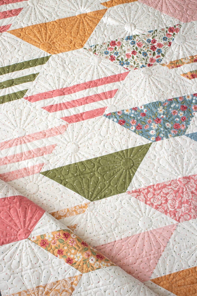 "Honey Glow" honeycomb hexagon quilt by Lella Boutique. Make it with a honeybun + fat quarters. Fabric is Wild Honey (Nov 2025). Download the PDF here.