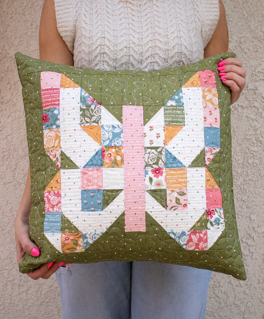 "Mini Charmed" scrappy butterfly pillow in Wild Honey Fabric. Make it with a mini charm pack. Download the PDF here!
