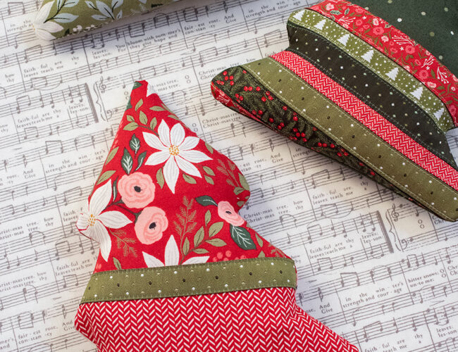 "Spruce It Up" stuffed tree pattern featuring a pocket for treats or love notes. Fabric and ribbon is Berry & Pine by Lella Boutique for Moda Fabrics. Download the PDF here.