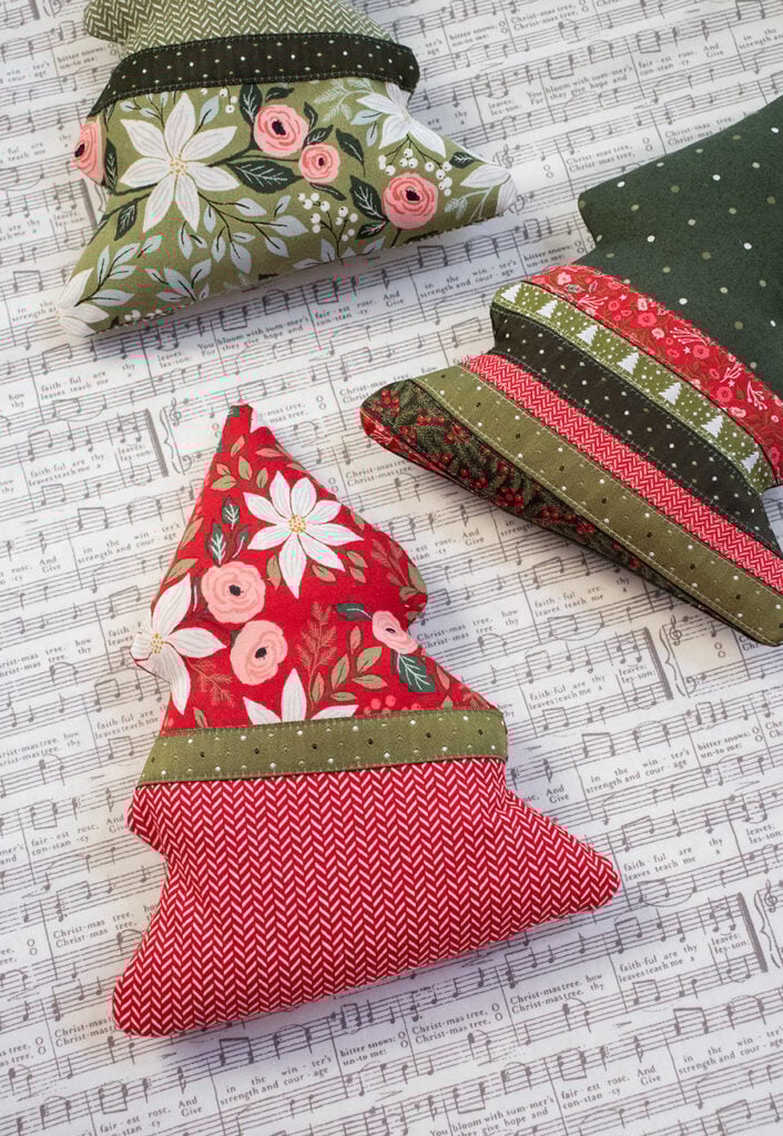 "Spruce It Up" stuffed tree pattern featuring a pocket for treats or love notes. Fabric and ribbon is Berry & Pine by Lella Boutique for Moda Fabrics. Download the PDF here.