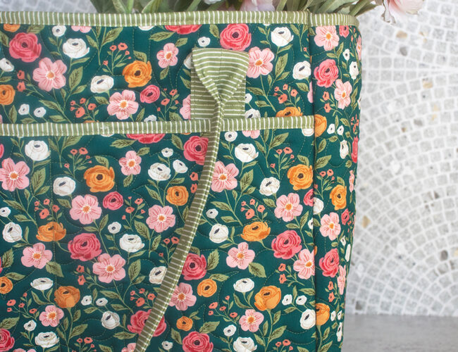 The Stitch and Stash tote bag pattern by Kaitlyn Howell of Knot and Thread. Fabric is Garden Glam by Lella Boutique or Moda Fabrics (Nov 2026). Download the PDF here!
