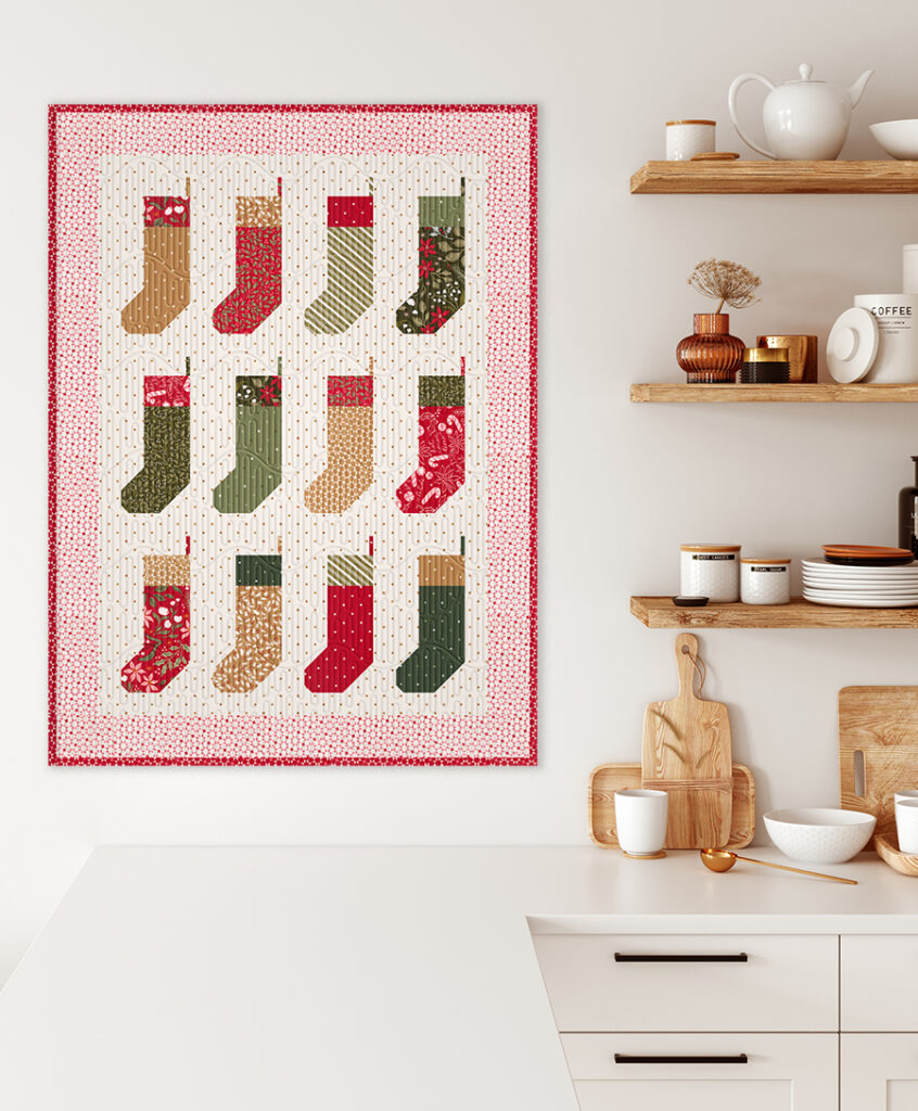 "By the Chimney Mini" stocking quilt wall hanging in Peppermint Cocoa by Lella Boutique for Moda Fabrics. Download the PDF here!