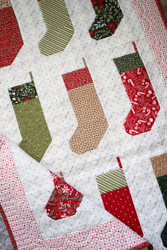 "By the Chimney Mini" stocking quilt wall hanging in Peppermint Cocoa by Lella Boutique for Moda Fabrics. Download the PDF here!