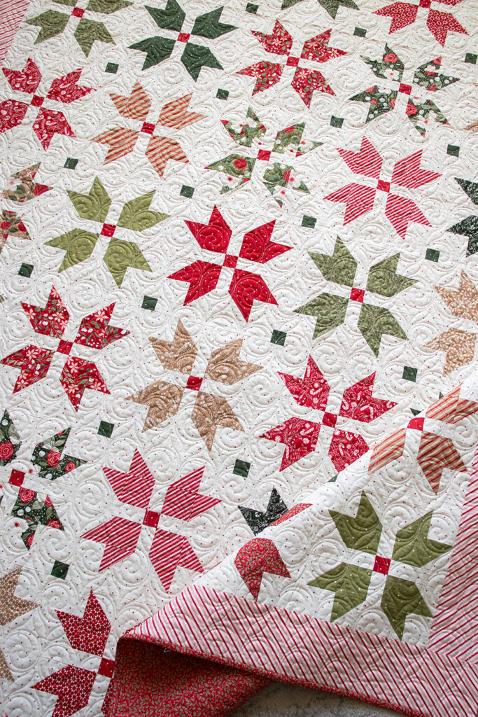"Merry Blooms" simple Christmas flower quilt by Vanessa Goertzen of Lella Boutique. Make it with fat eighths or fat quarters. Fabric is Peppermint Cocoa by Lella Boutique for Moda Fabrics. Download the PDF here!
