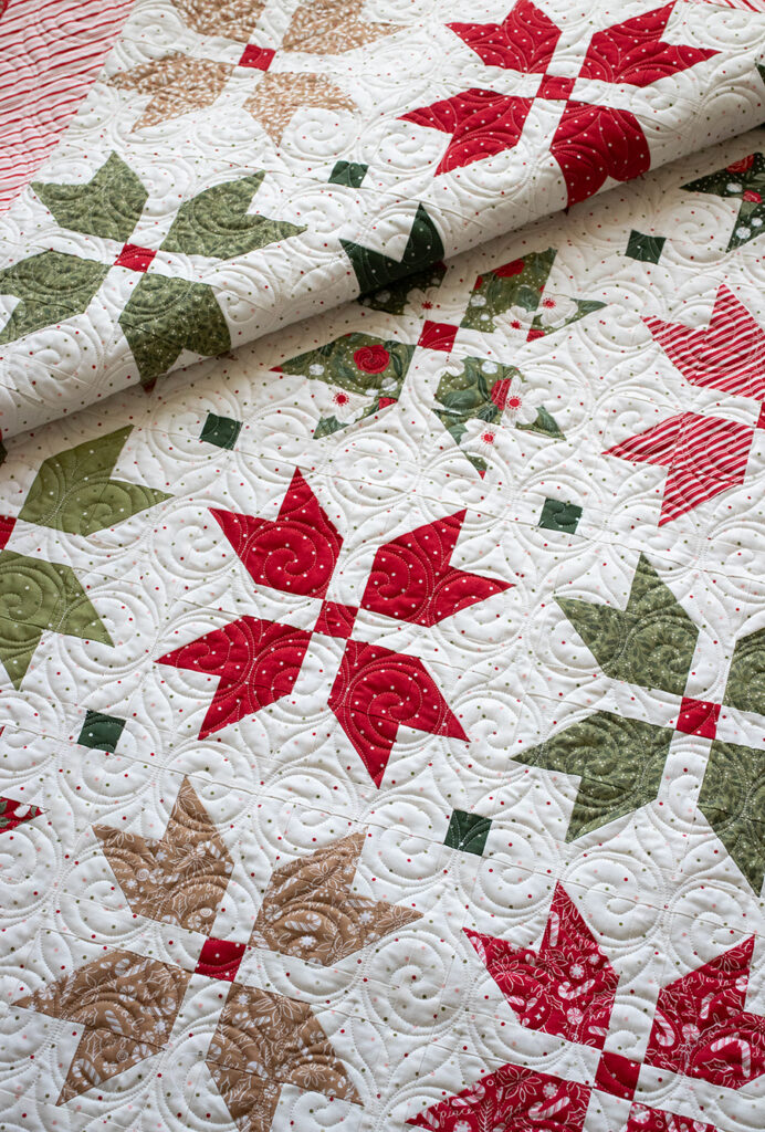 "Merry Blooms" simple Christmas flower quilt by Vanessa Goertzen of Lella Boutique. Make it with fat eighths or fat quarters. Fabric is Peppermint Cocoa by Lella Boutique for Moda Fabrics. Download the PDF here!