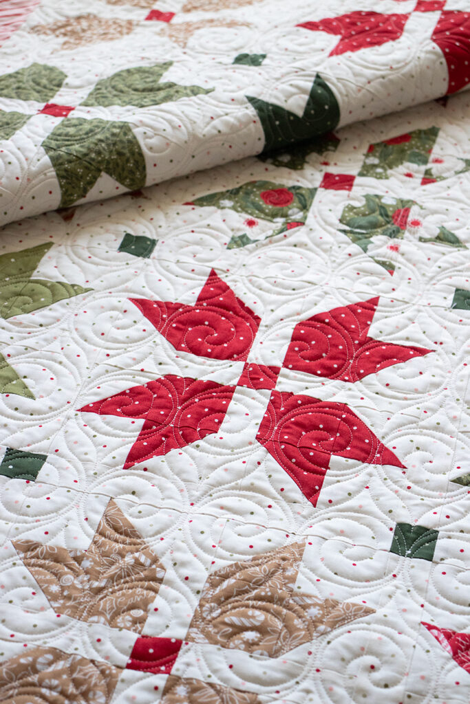 "Merry Blooms" simple Christmas flower quilt by Vanessa Goertzen of Lella Boutique. Make it with fat eighths or fat quarters. Fabric is Peppermint Cocoa by Lella Boutique for Moda Fabrics. Download the PDF here!