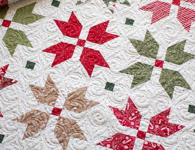 "Merry Blooms" simple Christmas flower quilt by Vanessa Goertzen of Lella Boutique. Make it with fat eighths or fat quarters. Fabric is Peppermint Cocoa by Lella Boutique for Moda Fabrics. Download the PDF here!