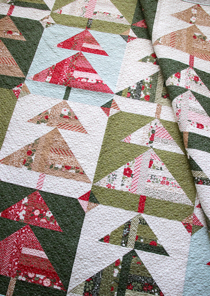 "Pine Needles" scrappy Christmas tree quilt made with a fat eighth bundle of Peppermint Cocoa fabric by Lella Boutique for Moda Fabrics. Download the PDF here!